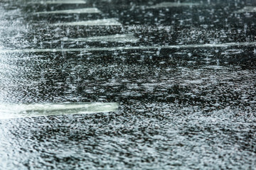 Fototapeta na wymiar Rain on the asphalt road as background