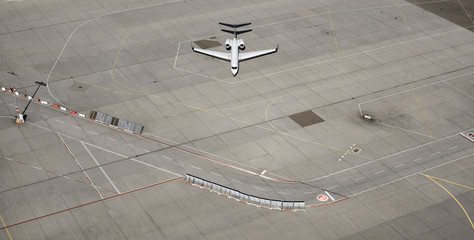 Aerial view private airplane parked on tarmac at airport