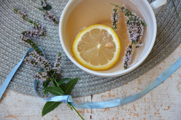  herbal tea with lemon and mint in a white mug