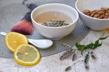  herbal tea with lemon and mint in a white mug