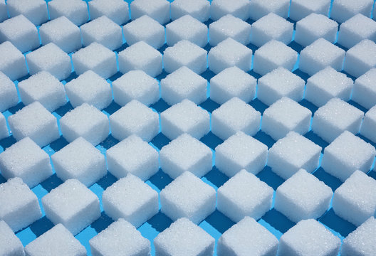 Full frame sugar cube checkered pattern on blue background