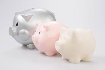 Piggy bank family side view three pig