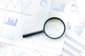 Magnifying glass with data Business Graphs finance Chart document.	
