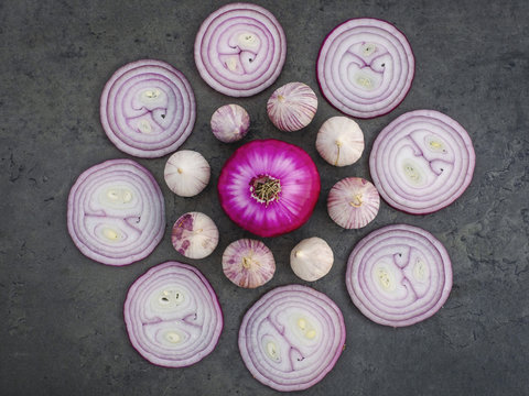 View from above round red onion and purple garlic arrangement