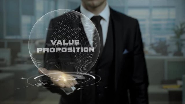 Executive dealer presenting strategy Value Proposition hologram. Entrepreneur in black suit holding cyber Earth with words on his hand.
