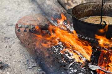 Burning neck of guitar and old sooty cauldron