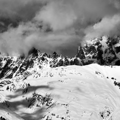 Black and white snowy rocks in haze at winter