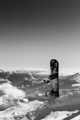 Black and white view on snowboard in snow on off-piste slope