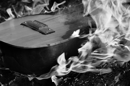 Black and white guitar in flame