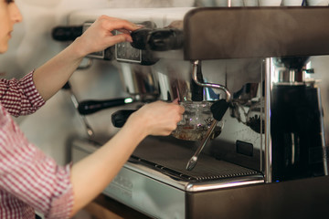 Barista using a coffee machine in cafe