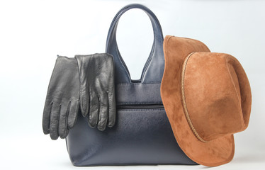 Fashionable leather bag, gloves, felt hat on a white background, autumn female accessories.