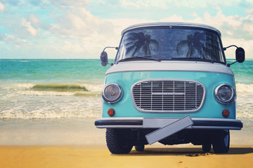 Vintage van parked on the beach against the sea