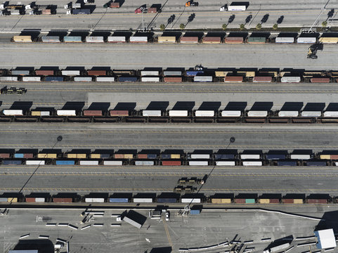 Aerial view trains in sunny shunting yard, Los Angeles, California, USA