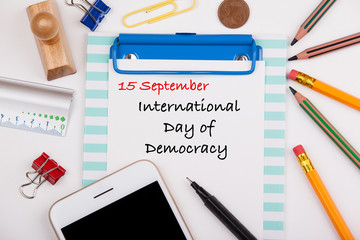 International Day of Democracy 15 September. Office desk with stationery and mobile phone