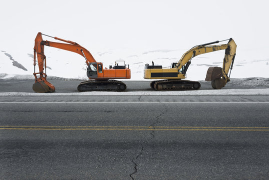 Road clearing excavators parked at roadside along Colony Glacier, Knik Valley, Anchorage, Alaska