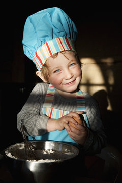 Portrait cute girl in chefs hat baking