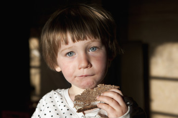 Portrait cute girl eating sandwich