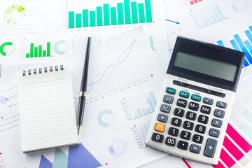Calculator and Pen with Business Graphs finance document.