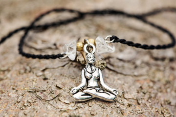 Closeup of bracelet with yoga girl in lotus position silver color pendant