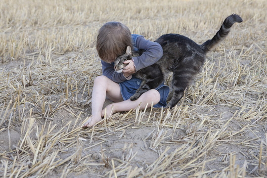 Affectionate girl hugging cat