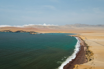 Natural reserve in Paracas, Peru. Blue sky, green sea, yellow cliffs, desert and ocean