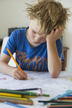 Focused boy coloring