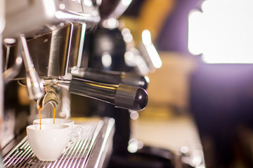 Barista make coffee espresso shot by streaming machine in coffee cafeteria bar. Brewing Process concept. coffee blending process. image for background, wallpaper,decoration and copy space.