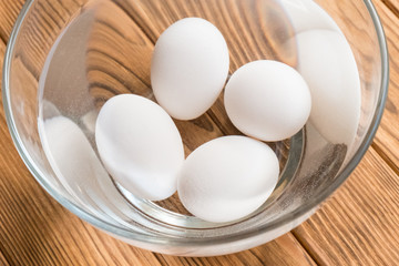 raw eggs in a bowl with water