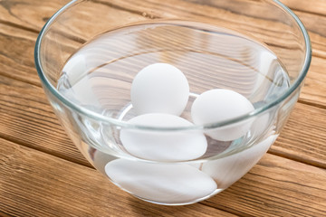 raw eggs in a bowl with water