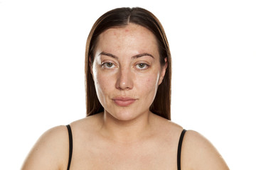 beautiful middle-aged serious woman without makeup on white background