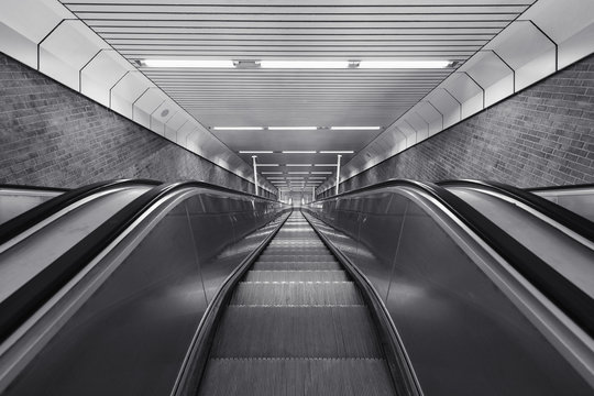 Black and white of descending escalator