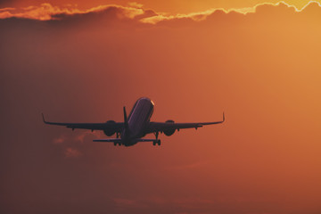 Aircraft taking off in the sunset - obrazy, fototapety, plakaty