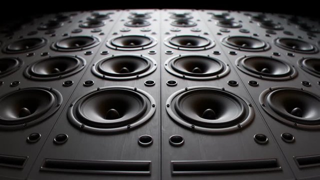 Modern speakers stacked in an endless wall loop. Membranes vibrate, studio mood.