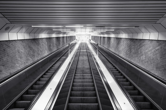 Black and white of ascending escalator