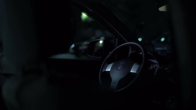 Unidentified carjacker starting car engine on night parking, stealing property