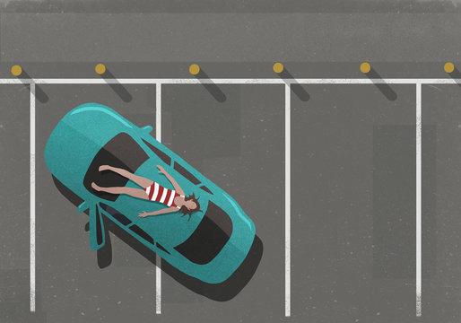 Woman in bathing suit sunbathing on top of car in parking lot