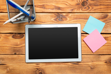 White digital tablet on wooden table