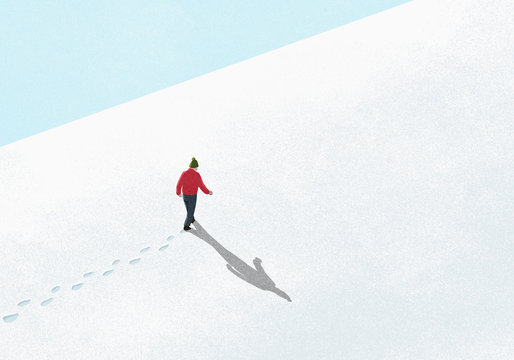 Man walking up snowy slope