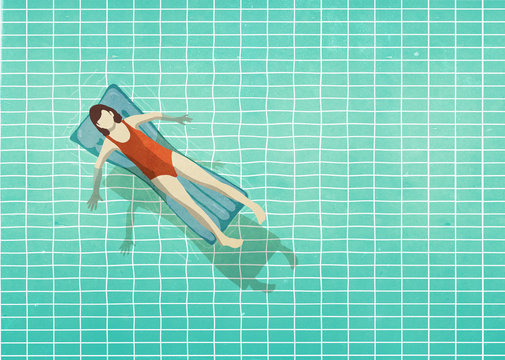 Woman in bathing suit laying on inflatable raft in swimming pool