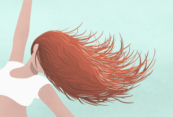 Carefree woman dancing, flipping hair over face