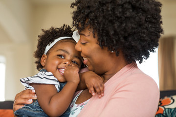 African American family. Mother and daughter smiling at home.