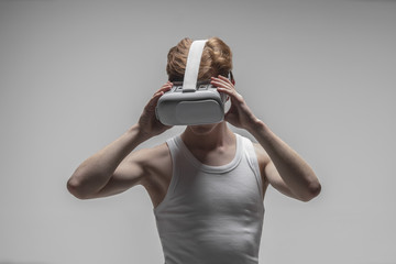 Young man using virtual reality simulator glasses