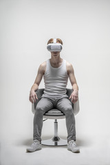 Young man using virtual reality simulator glasses