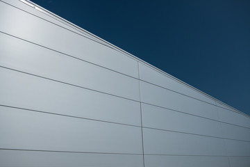 Modern building facade covered with steel sandwich panels in silver color