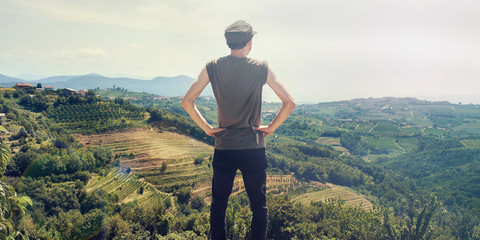 young man looking vineyard landscape, agriculture pride concept
