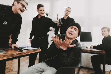 Policeman Put A Gun On A Suspect In Handscuffs.