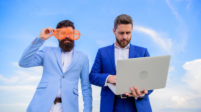 Unprofessional behaviour. How stop play entrepreneurship and get serious business. Event management industry. Businessman with laptop serious while business partner ridiculous glasses looks funny