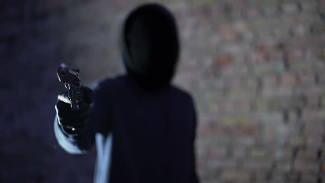 Anonymous hooligan threatening with gun, robbery aggression, armed criminal