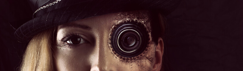 Steampunk girl portrait on black. Monocular lens