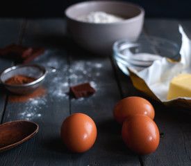 Ingredients for chocolate brownies on dark background 